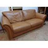 A 6' 5" Laura Ashley two seater settee upholstered in brown leather, set on wooden block feet