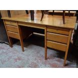 A 4' 6" vintage Sapele and mixed wood kneehole office desk by Carsons Office Furniture, with six