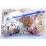 A bag containing a quantity of loose beads and part necklaces, etc.