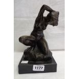 A bronzed seated nude lady