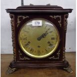 A reproduction stained wood cased bracket clock with ornate dial, bezel detached but included and