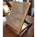 An old polished wood rattan panel back rest with ratchet action