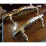 Two reproduction ornate gilt wall brackets with shaped shelf tops and Rococo style supports