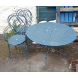 A painted metal garden table with a set of four chairs to match