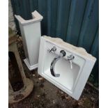 A modern pedestal wash basin with fittings