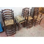 A set of six stained oak framed ladder back dining chairs with woven rush seats and a footstool to