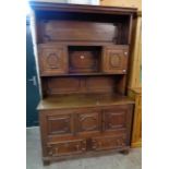 A 4' antique oak two part dresser in the Jacobean style with moulded cornice, open shelves and