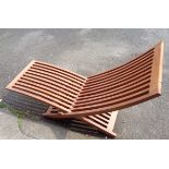 A stained and slatted teak adjustable sun lounger