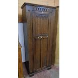 A 30" 20th Century polished oak hall wardrobe with part linen fold decoration to panelled door,