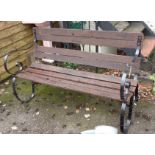 A 4' 4" wrought iron garden bench with slatted seat