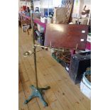 A late Victorian brass adjustable music stand with candle sconce, walnut surface and ornate