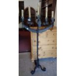 A painted wrought iron five branch torchere style standard lamp with barley twist pillar and