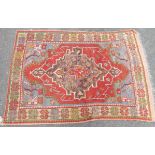 A Middle Eastern rug with central medallion and spandrels - 4' 4" X 3' 4" (132cm X 102cm) - worn