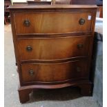 A 21" reproduction mahogany serpentine front chest of three long drawers, set on bracket feet