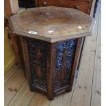 A 21" old Indian brass inlaid hardwood octagonal topped table, set on an ornate folding faceted base