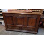 A 4' 10" 19th Century oak mule chest with internal candle box, decorative carved frieze, triple