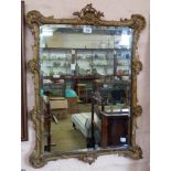 A Rococo style ornate gilt framed bevelled oblong wall mirror