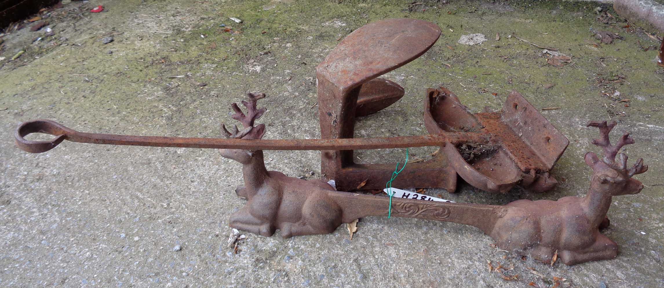 A cast iron boot scrape with stag pattern ends - sold with a pig pattern doorstop and a cobbler's