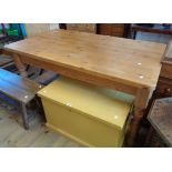 A 5' late 20th Century waxed pine kitchen table with heavy sectional top, set on turned legs