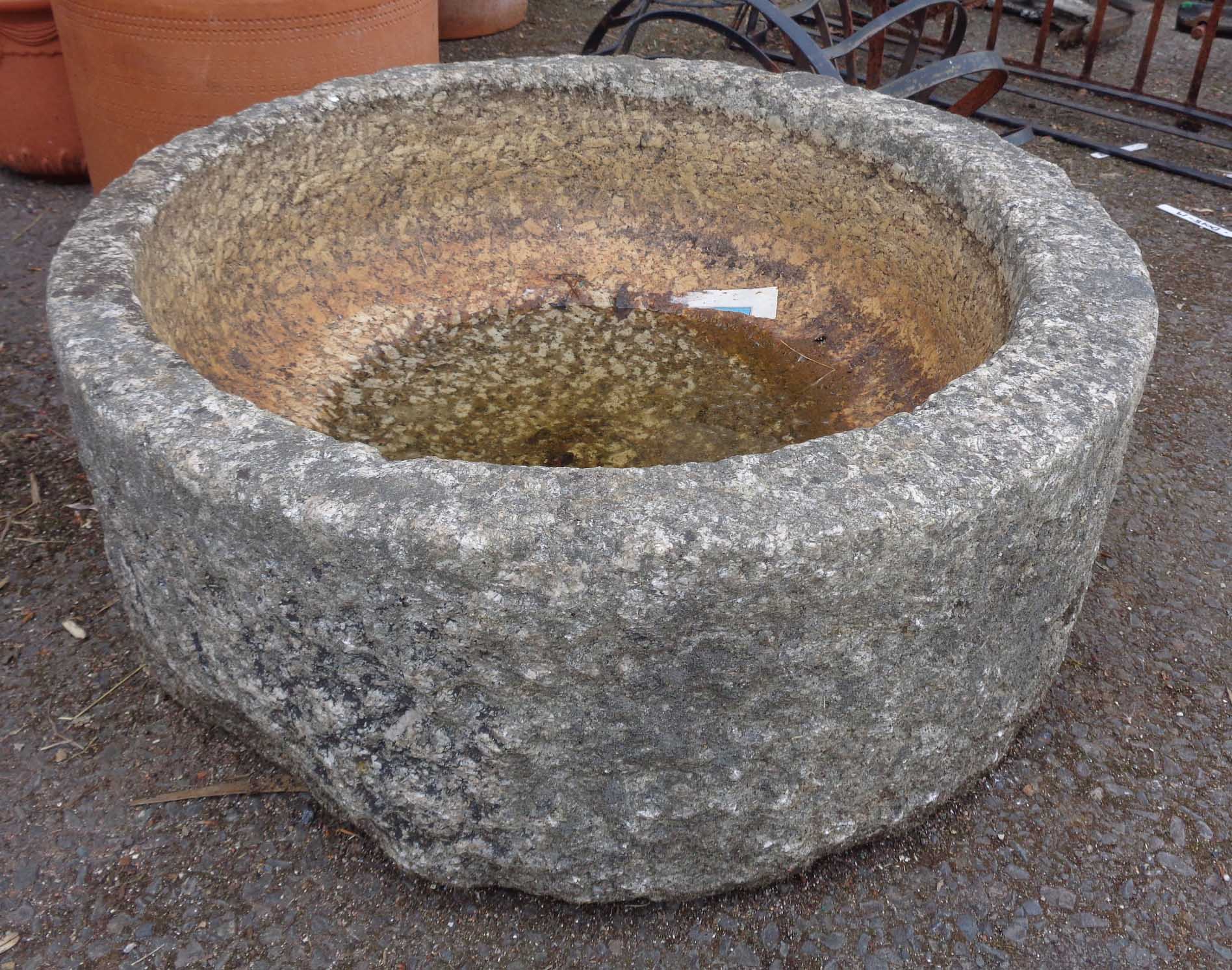 A circular granite trough with polished interior - diameter 25"