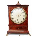 A Regency brass strung flame mahogany cased table clock with 7 1/2" diameter slightly domed dial,