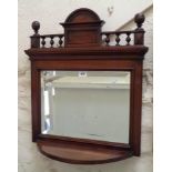 An Edwardian walnut bevelled oblong wall mirror with balustrade pediment and shelf under