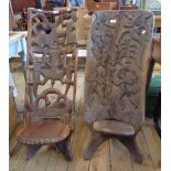 Two Malawian chief's chairs, one with decorative pierced back the other with figures, baboons,