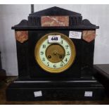 A late Victorian black slate and red marble cased mantel clock of architectural design with eight