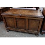 A 3' 4" early 20th Century oak linen chest with tray fitted interior and triple panel front, set