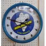 A reproduction tin cased Michelin wall timepiece with battery movement