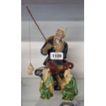 Two seated Chinese figures - sold with a Chinese fisherman