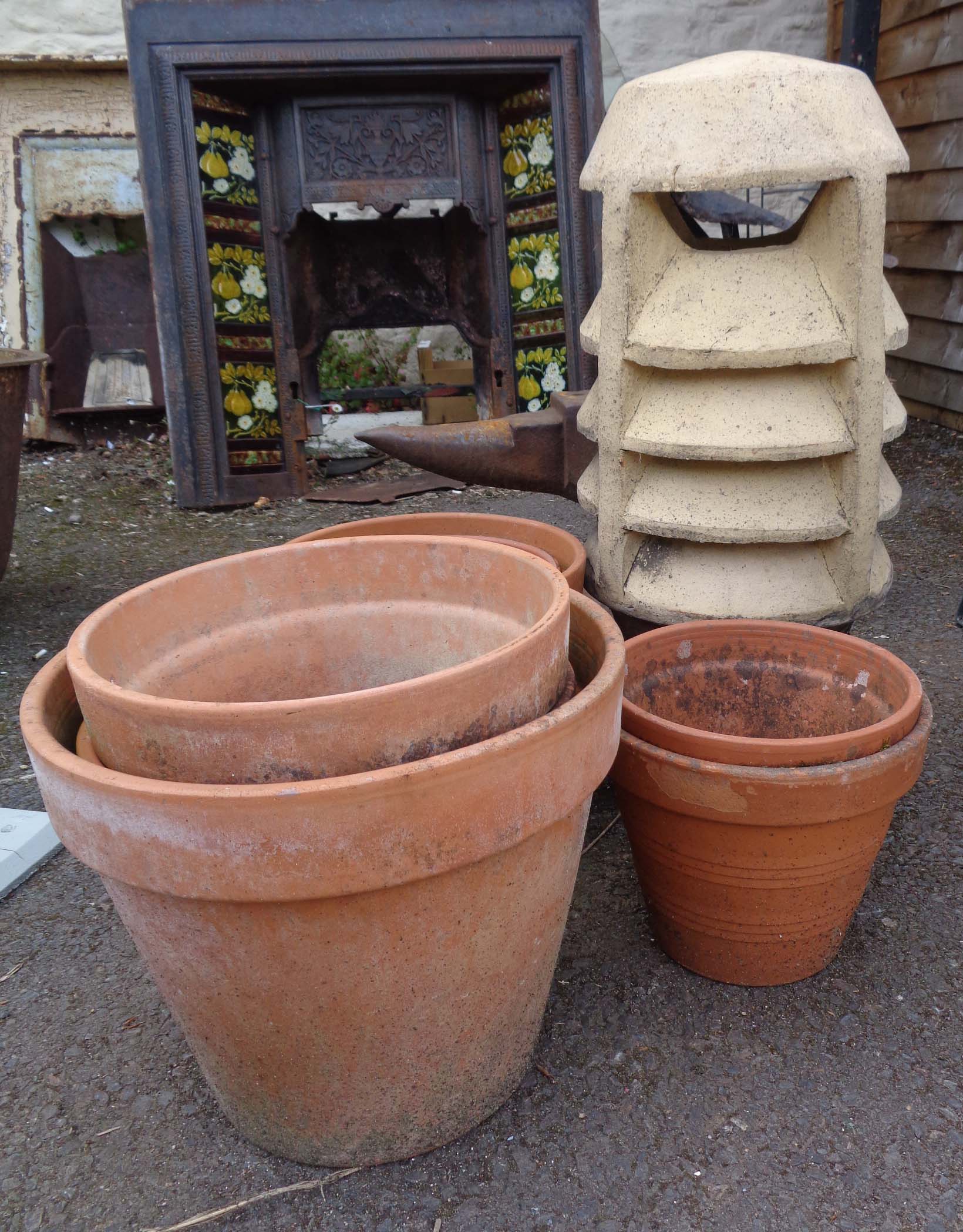 A terracotta chimney pot - sold with six large terracotta pots