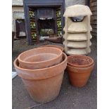 A terracotta chimney pot - sold with six large terracotta pots