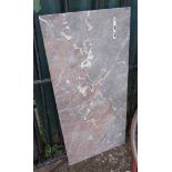 A slab of pink and grey marble