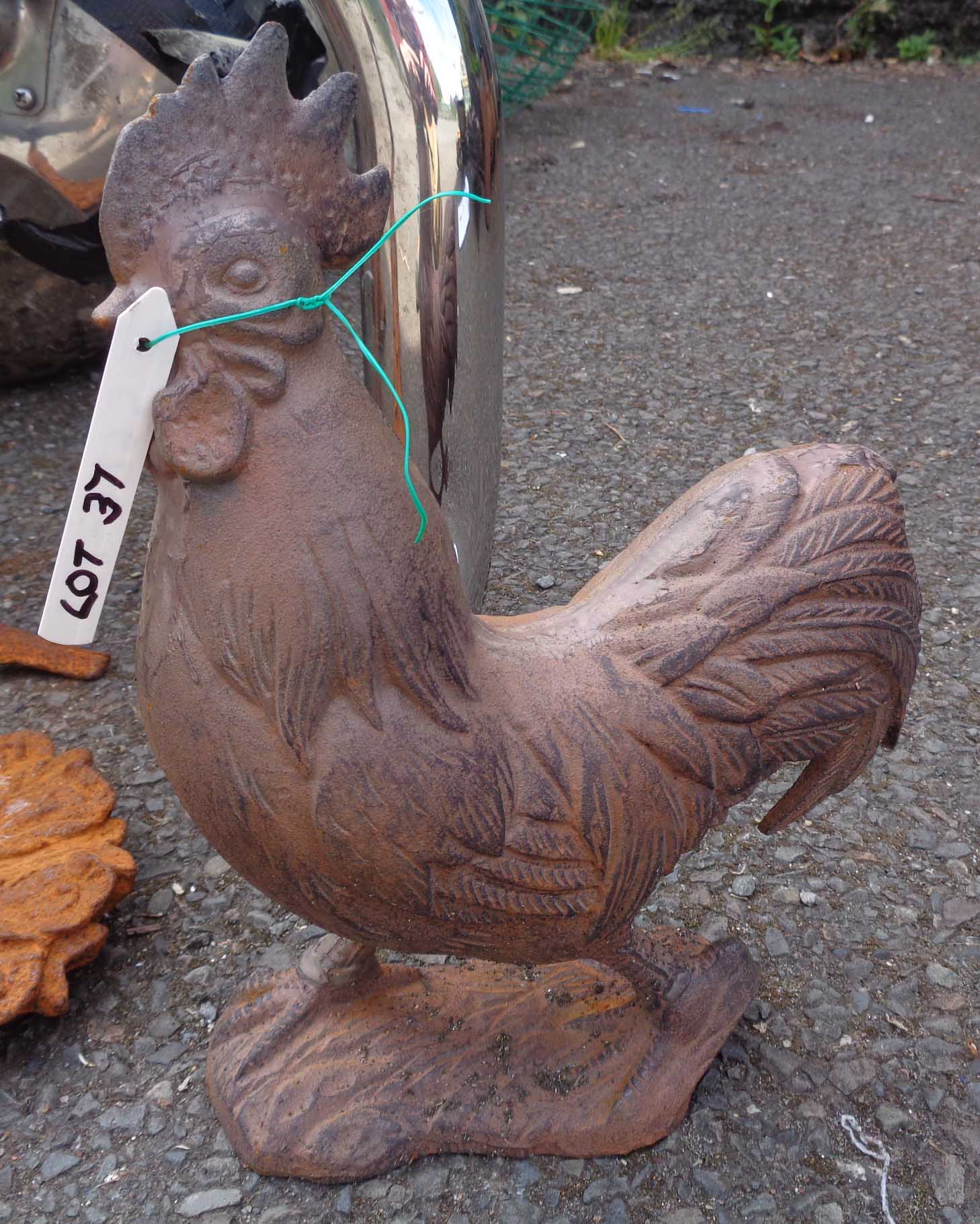 A cast iron cockerel with rusted finish