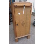 An oak bedside cabinet with slide