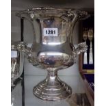 A 9 1/2" silver plated campagna shaped champagne bucket with cast vine rim and flanking handles