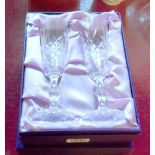 A boxed pair of Edinburgh Crystal champagne flutes and a matching pair of wines