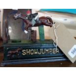 A reproduction painted cast iron horse and rider Show Jumper money box