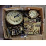 A box containing clock movements, pendulums, etc.