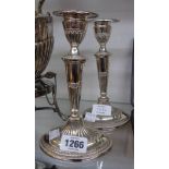 A pair of 7 3/4" Georgian style silver plated candlesticks with detachable nozzles and loaded oval