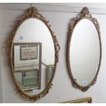 Two similar decorative gilt metal framed oval wall mirrors