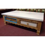 A 3' 11 1/4" part painted pine low coffee table with four drawers and shaped apron, set on moulded