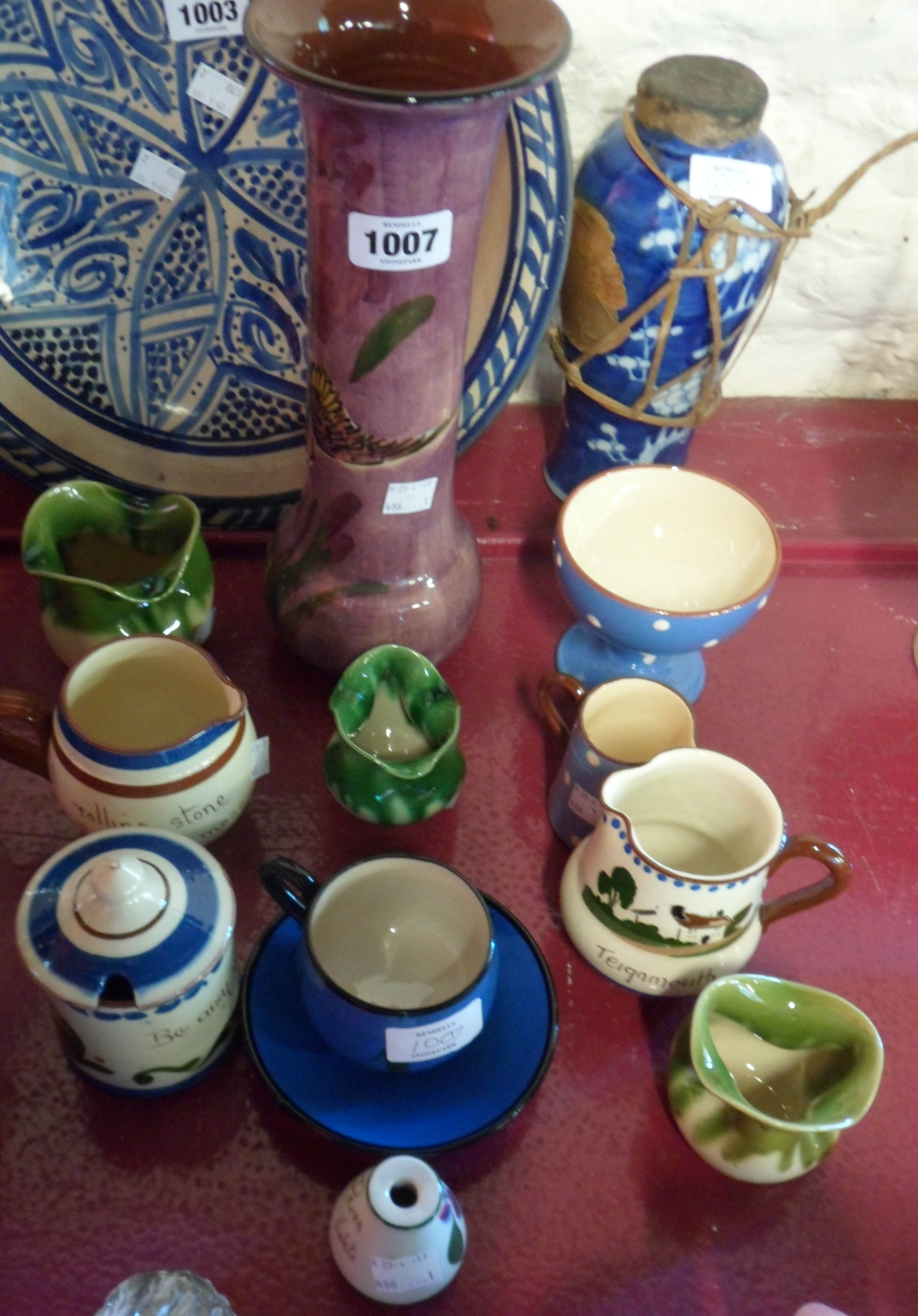 A collection of Torquay pottery including marmalade pot, cup with saucer, violet pot, vase (a/f),