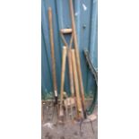 A quantity of garden tools including pitch fork, potato fork, sledge hammer, etc.