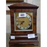 An antique mahogany cased table timepiece with brass and silvered dial and simple platform