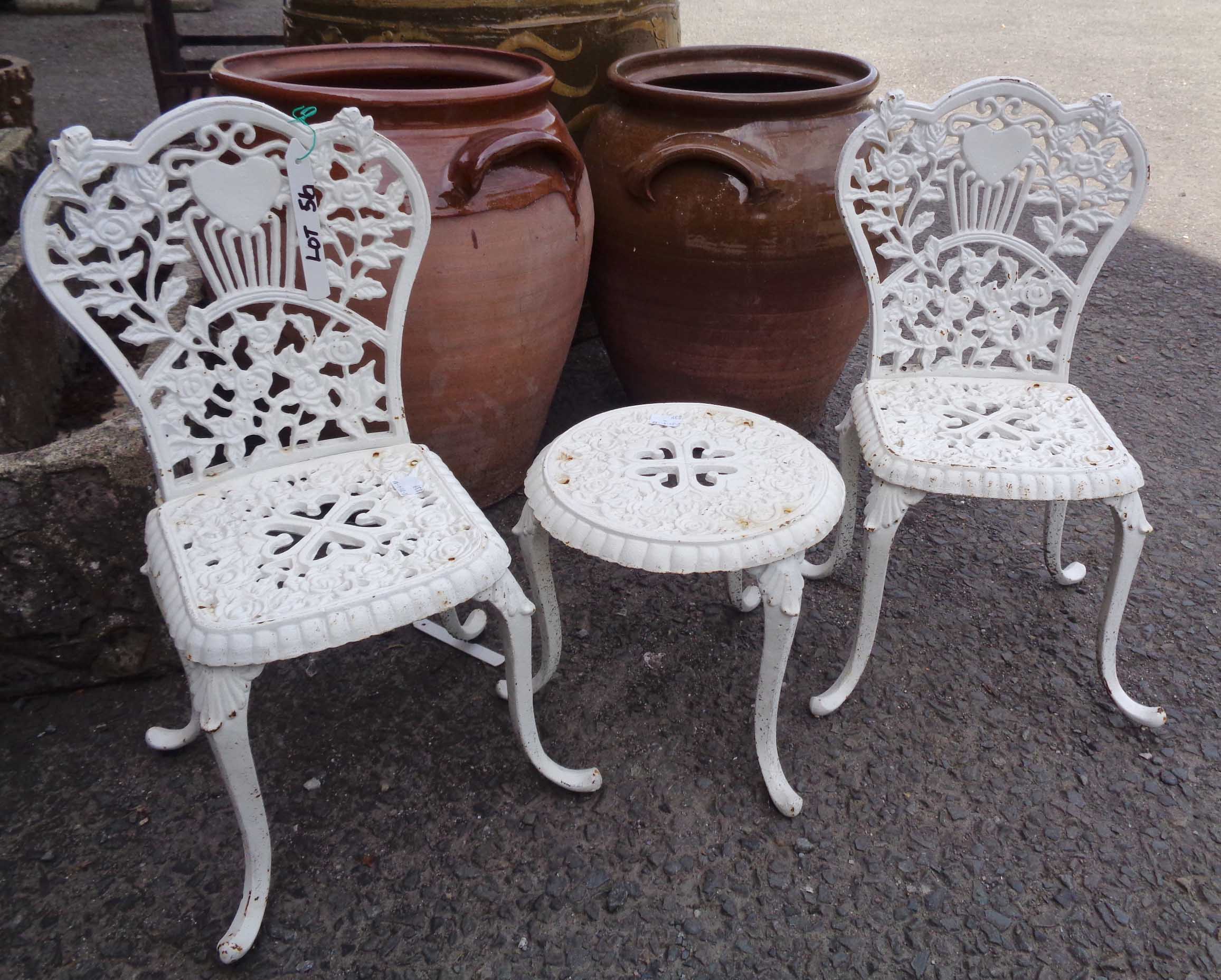 A pair of miniature garden seats and matching table