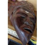 A pair of 20th Century Haitian carved wood decorative masks