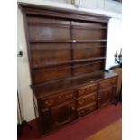 A 6' antique polished oak two-part dresser with shallow two shelf open plate rack over a base with