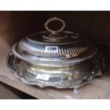 A silver plated oval entrée dish with detachable handle and reeded decoration - sold with a large